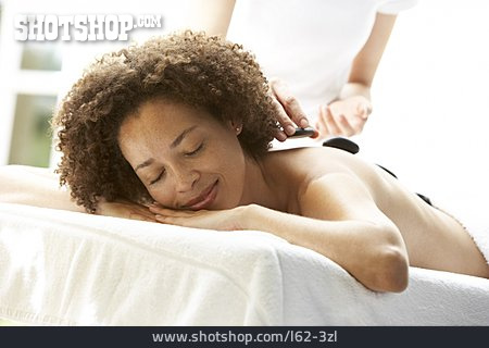 
                Junge Frau, Entspannen, Spa, Warmsteinmassage                   
