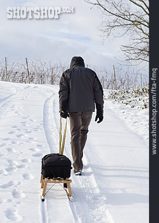 
                Mann, Schlitten, Winterspaziergang                   