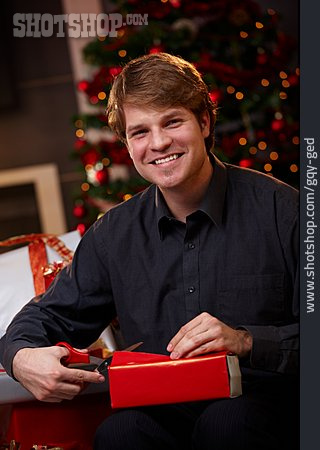 
                Junger Mann, Verpacken, Weihnachtsvorbereitung                   