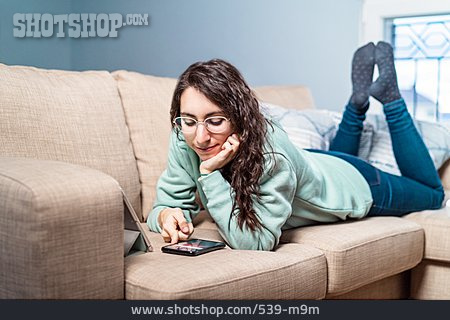 
                Frau, Zuhause, Liegen, Sofa, Entspannt, Smartphone                   